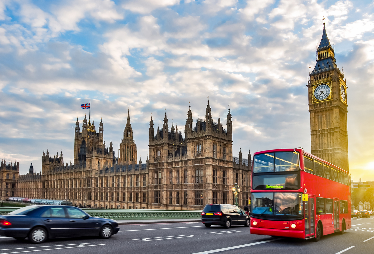 Houses of Parliament with Big Ben and double-decker bus on Westminster bridge at sunset, London, UK fully promoted franchise london
