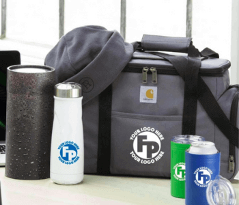 A gray insulated cooler bag, a towel, a white water bottle, a black tumbler, and two canned drinks with customizable logos are displayed on a table.