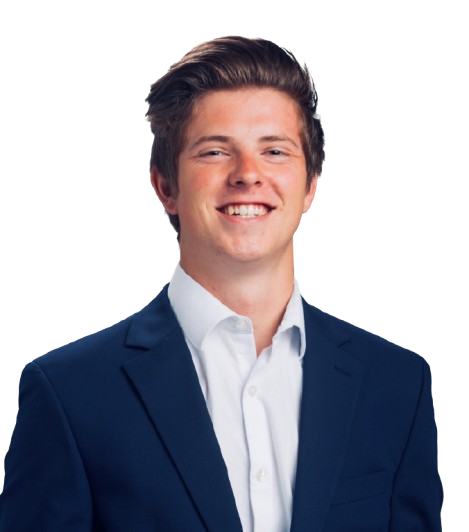 A person in a suit smiling against a plain white background. A person in a suit smiling against a plain white background.